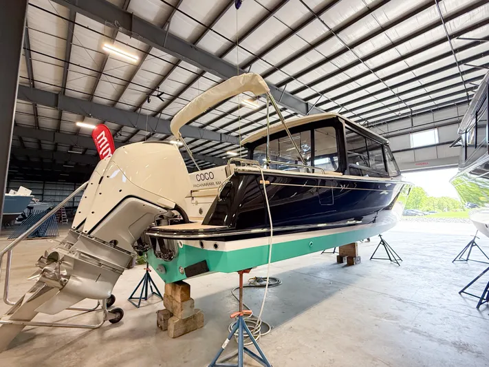 Coco Yacht Photos Pics 2022 MJM 3 boat in a storage facility, elevated on blocks.