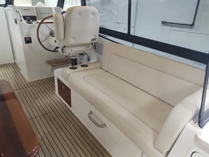 Coco Yacht Photos Pics 2022 MJM 3z boat interior with beige seating and wooden flooring.