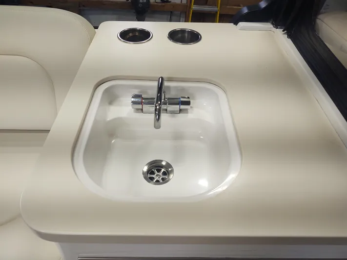 Coco Yacht Photos Pics Compact sink with faucet on MJM 3z 2022 boat, featuring dual cup holders.