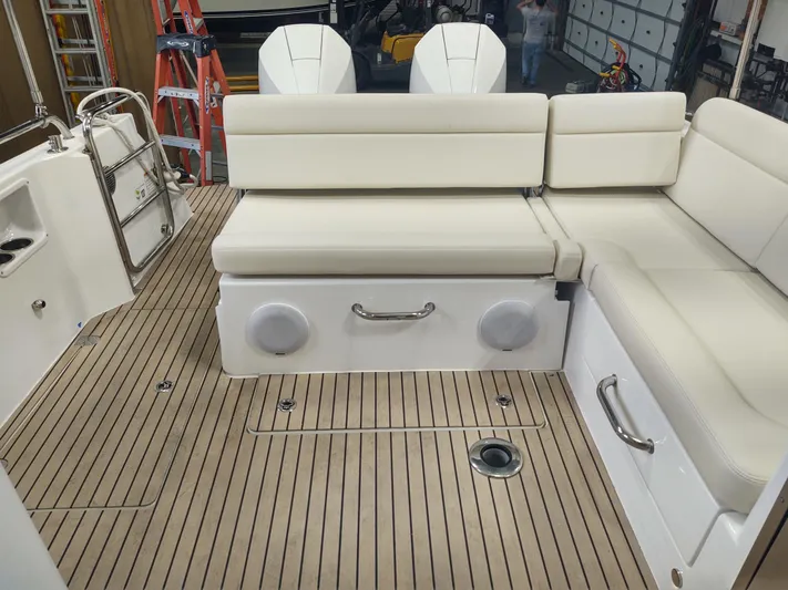 Coco Yacht Photos Pics MJM 3z 2022 boat interior with white seating and teak flooring.