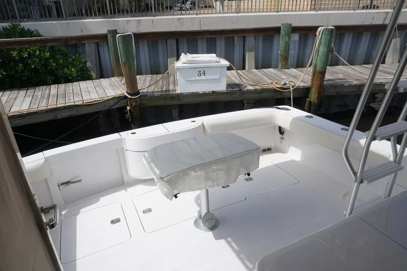 Sea Striker Yacht Photos Pics 2005 Mirage Yachts 40 Convertible, spacious deck area with seating, docked at marina.