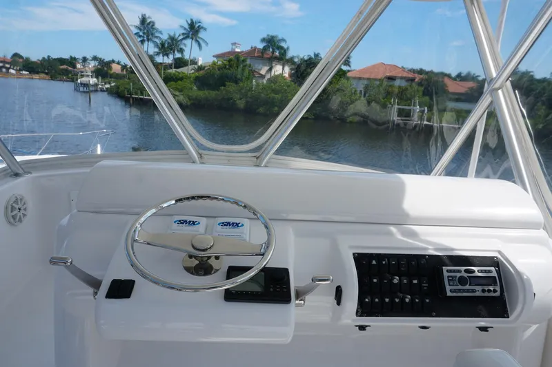 Sea Striker Yacht Photos Pics Helm of 2005 Mirage Yachts 40 Convertible with scenic waterfront view.