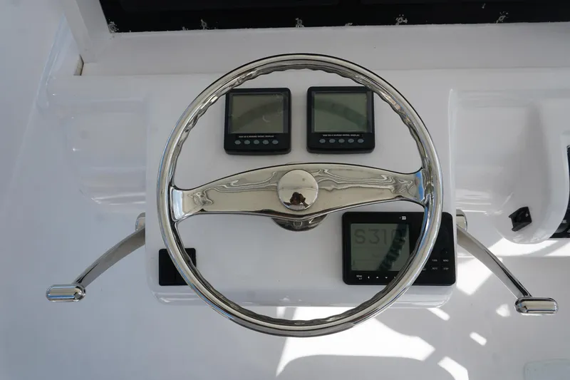 Sea Striker Yacht Photos Pics Steering wheel and controls of 2005 Mirage Yachts 40 Convertible boat.