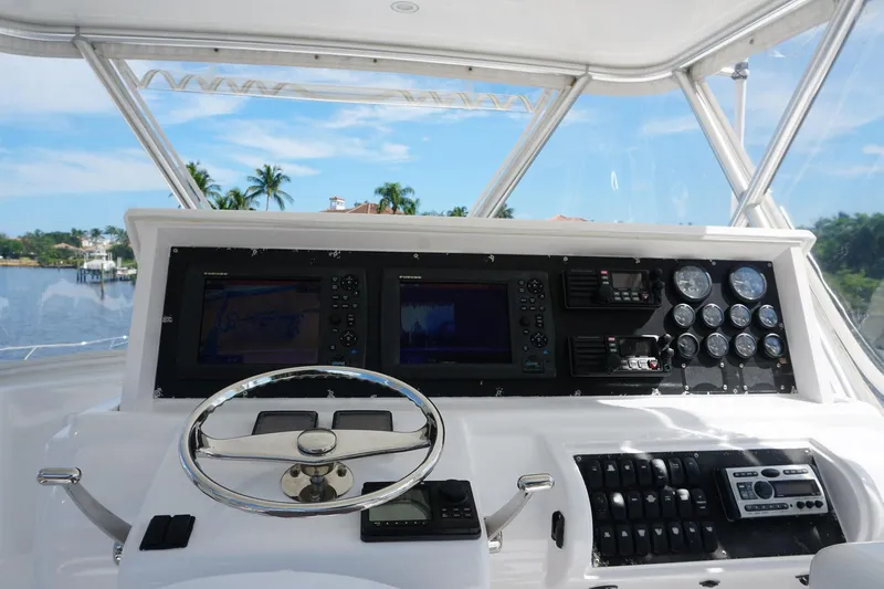 Sea Striker Yacht Photos Pics Helm of 2005 Mirage Yachts 40 Convertible with navigation instruments and steering wheel.