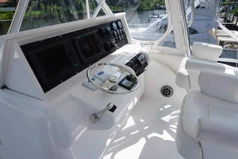 Sea Striker Yacht Photos Pics 2005 Mirage Yachts 40 Convertible helm with modern controls and white seating.