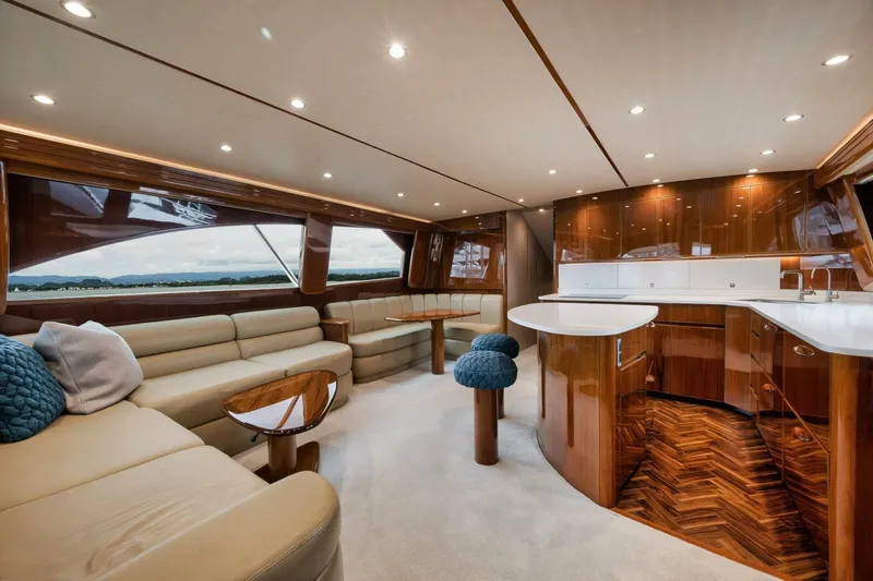 Triple Trouble Yacht Photos Pics Luxurious interior of 2014 Viking 62 Convertible yacht with elegant wood finishes and modern seating.