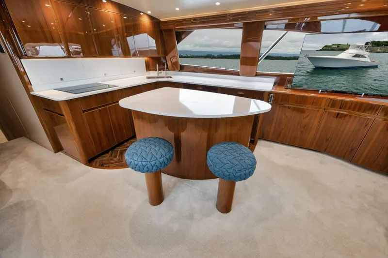 Triple Trouble Yacht Photos Pics Luxurious interior of 2014 Viking 62 Convertible yacht with elegant wood finishes.