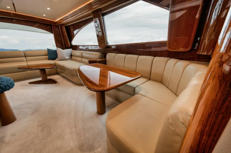 Triple Trouble Yacht Photos Pics Luxurious interior of 2014 Viking 62 Convertible yacht with plush seating and wooden accents.
