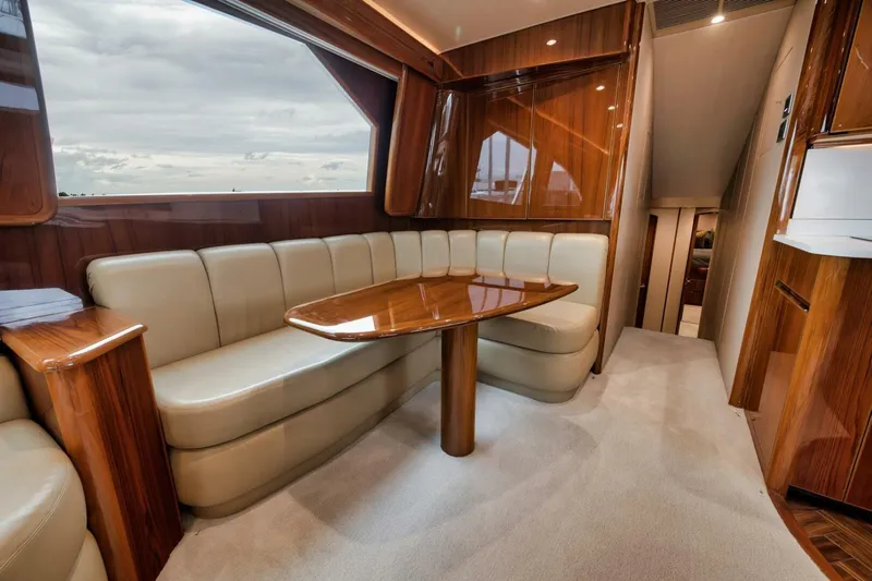 Triple Trouble Yacht Photos Pics Luxurious interior of 2014 Viking 62 Convertible yacht with elegant seating and wooden finishes.