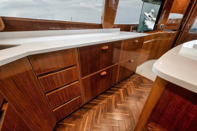 Triple Trouble Yacht Photos Pics Luxurious interior of 2014 Viking 62 Convertible yacht with elegant wood cabinetry and flooring.