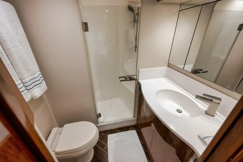 Triple Trouble Yacht Photos Pics Luxurious bathroom in 2014 Viking 62 Convertible yacht with modern fixtures and shower.