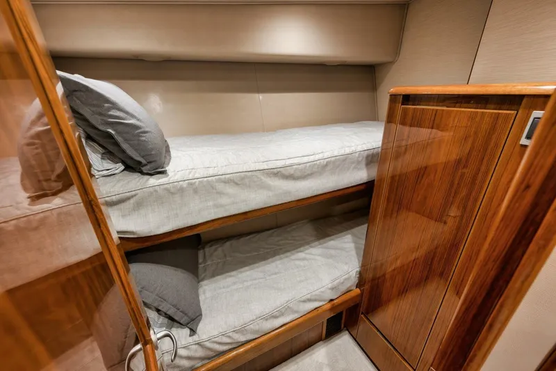 Triple Trouble Yacht Photos Pics Bunk beds in 2014 Viking 62 Convertible yacht cabin with wooden finishes.