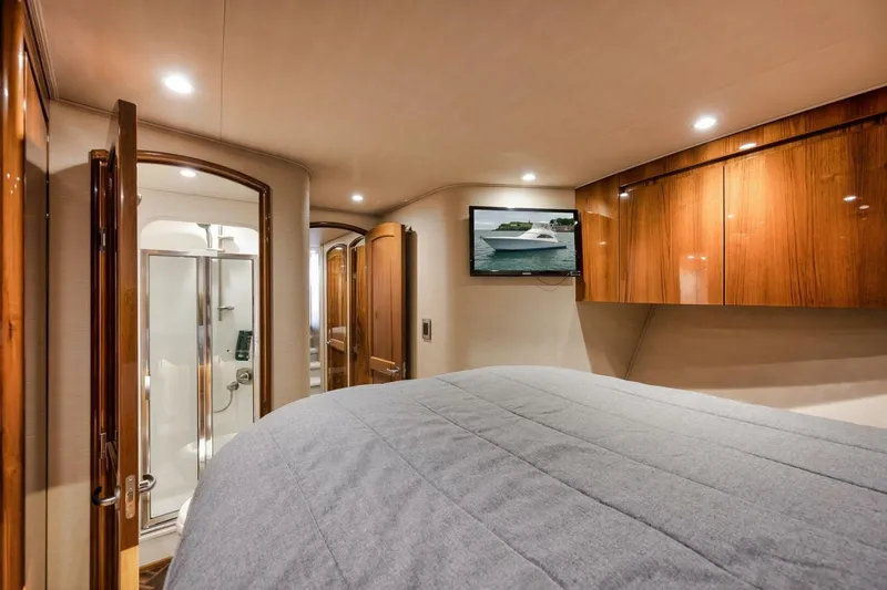 Triple Trouble Yacht Photos Pics Luxurious interior of 2014 Viking 62 Convertible yacht with wood finishes and modern amenities.