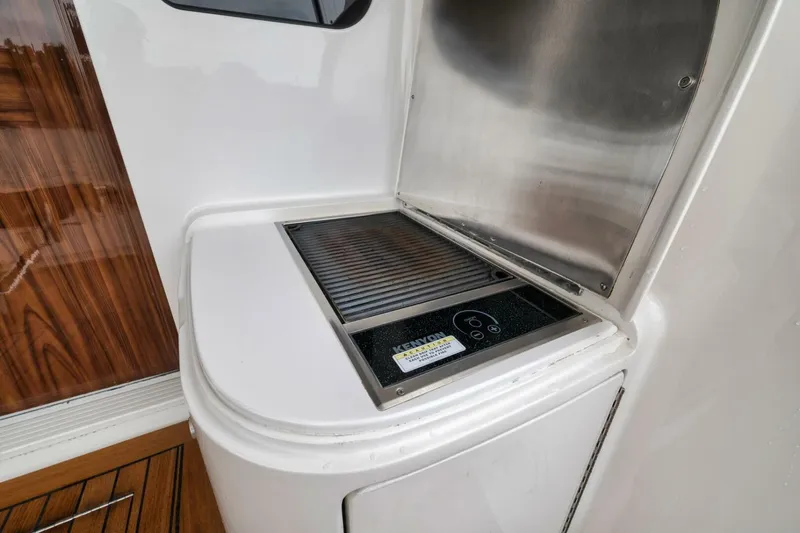 Triple Trouble Yacht Photos Pics Outdoor grill on 2014 Viking 62 Convertible yacht, featuring sleek stainless steel design.