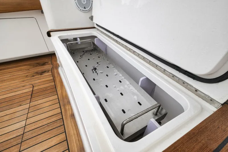 Triple Trouble Yacht Photos Pics Open storage compartment on 2014 Viking 62 Convertible yacht with wooden deck.
