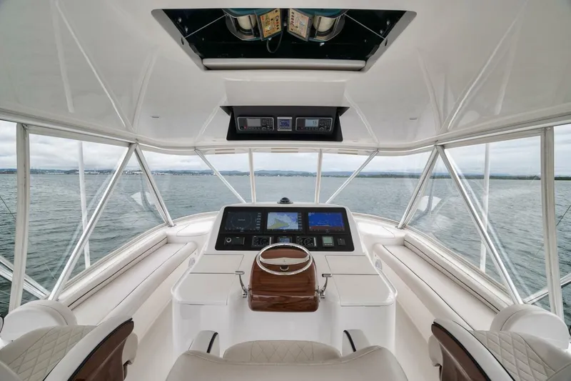 Triple Trouble Yacht Photos Pics 2014 Viking 62 Convertible yacht helm with panoramic ocean view and advanced navigation systems.