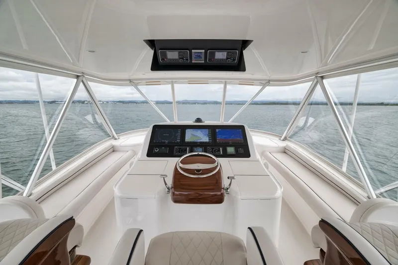 Triple Trouble Yacht Photos Pics Helm of 2014 Viking 62 Convertible yacht with modern navigation equipment.