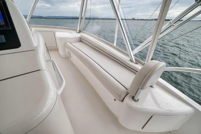 Triple Trouble Yacht Photos Pics Luxurious seating area on a 2014 Viking 62 Convertible yacht, overlooking the ocean.