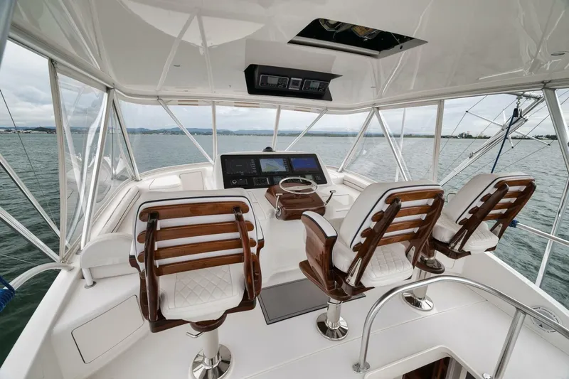 Triple Trouble Yacht Photos Pics Flybridge of 2014 Viking 62 Convertible yacht with helm station and seating.
