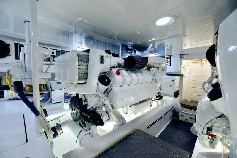 Triple Trouble Yacht Photos Pics Engine room of 2014 Viking 62 Convertible yacht, showcasing powerful machinery and clean design.