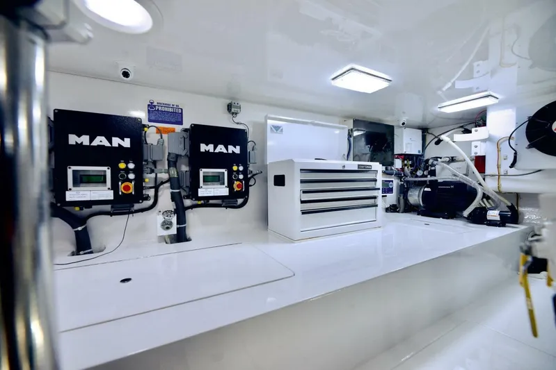 Triple Trouble Yacht Photos Pics Engine room of 2014 Viking 62 Convertible yacht with MAN engines and tool storage.