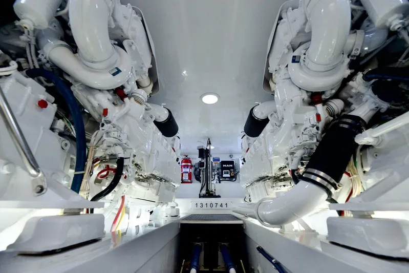 Triple Trouble Yacht Photos Pics Engine room of 2014 Viking 62 Convertible yacht, showcasing dual engines and equipment.