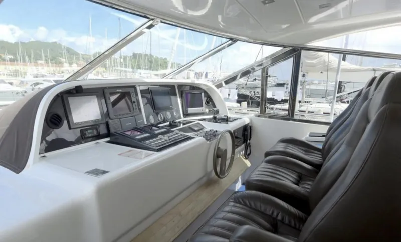  Yacht Photos Pics Cockpit of 2006 Mangusta 80 yacht with leather seats and navigation controls.