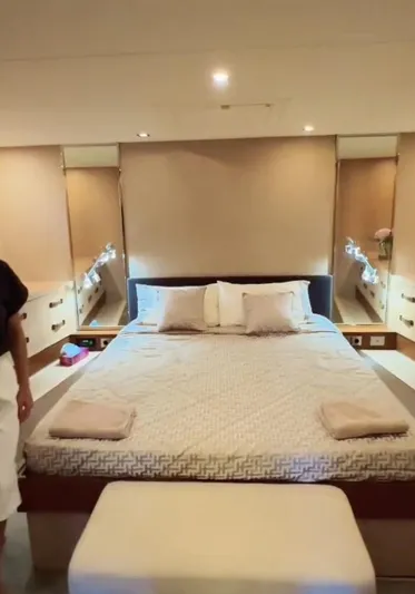  Yacht Photos Pics Luxurious bedroom interior of 2006 Mangusta 80 yacht with modern design and cozy bedding.