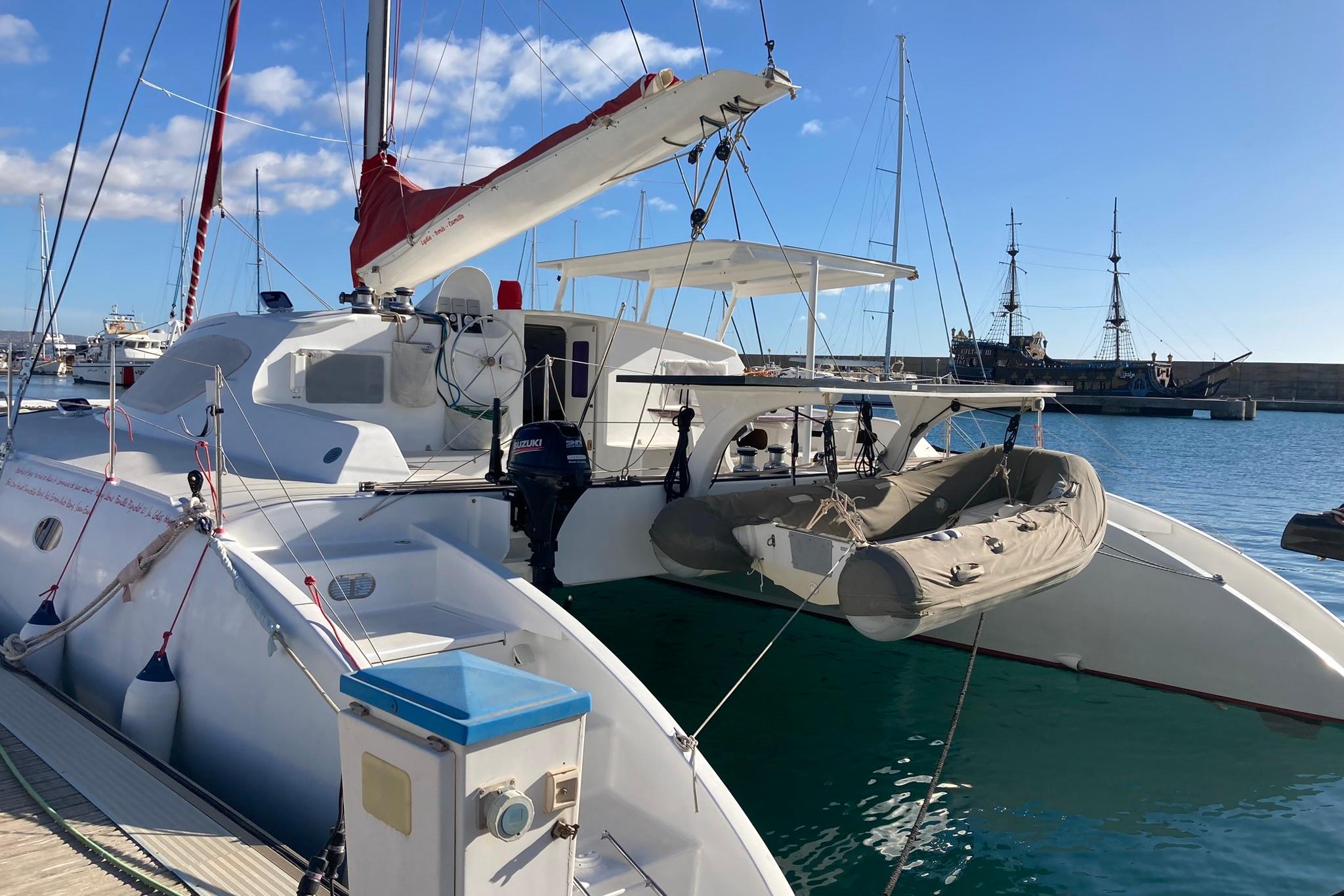 Catamaran Looping 50, 2017 model, docked at marina with inflatable boat.