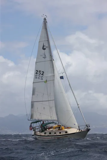 Hero Yacht Photos Pics 1992 Pacific Seacraft 37 Cutter sailing on open sea under cloudy skies.