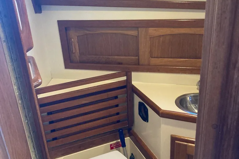 Hero Yacht Photos Pics Interior of 1992 Pacific Seacraft 37 Cutter, featuring wooden cabinetry and compact sink.