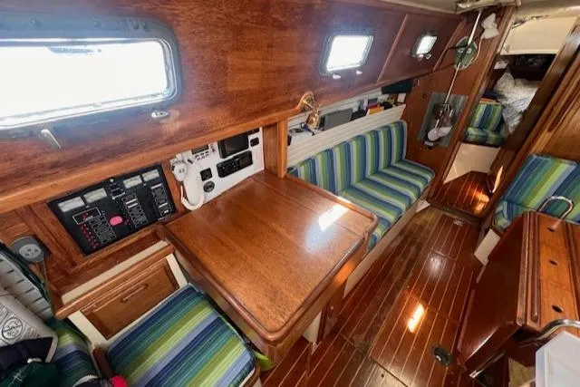 Hero Yacht Photos Pics Interior of 1992 Pacific Seacraft 37 Cutter with wood finish and striped seating.