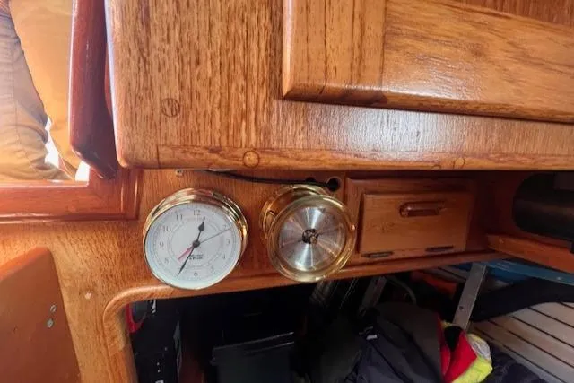 Hero Yacht Photos Pics Interior of 1992 Pacific Seacraft 37 Cutter with wooden cabinetry and nautical instruments.