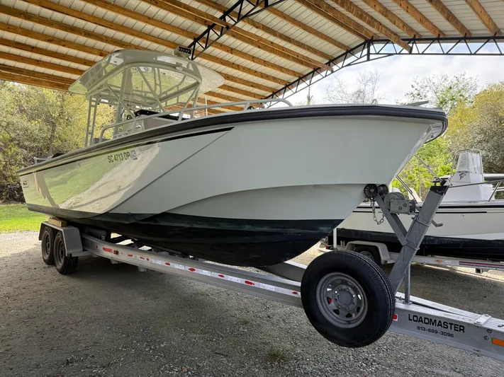  Yacht Photos Pics 2004 Boston Whaler Guardian 27 on trailer under a metal canopy.