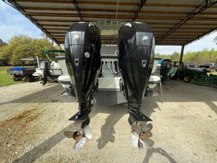  Yacht Photos Pics Twin outboard motors on a 2004 Boston Whaler Guardian 27 under a metal canopy.