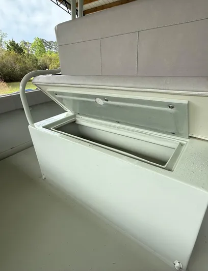  Yacht Photos Pics 2004 Boston Whaler Guardian 27 storage compartment with open lid, showcasing interior space.