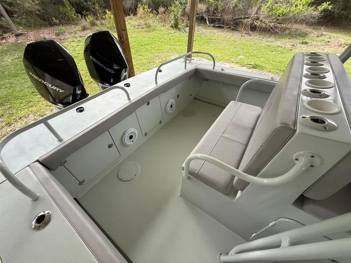  Yacht Photos Pics 2004 Boston Whaler Guardian 27 boat interior with seating and storage compartments.