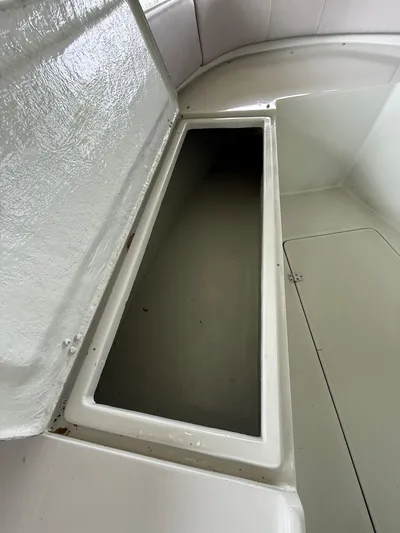  Yacht Photos Pics 2004 Boston Whaler Guardian 27 storage compartment, open lid, white interior.