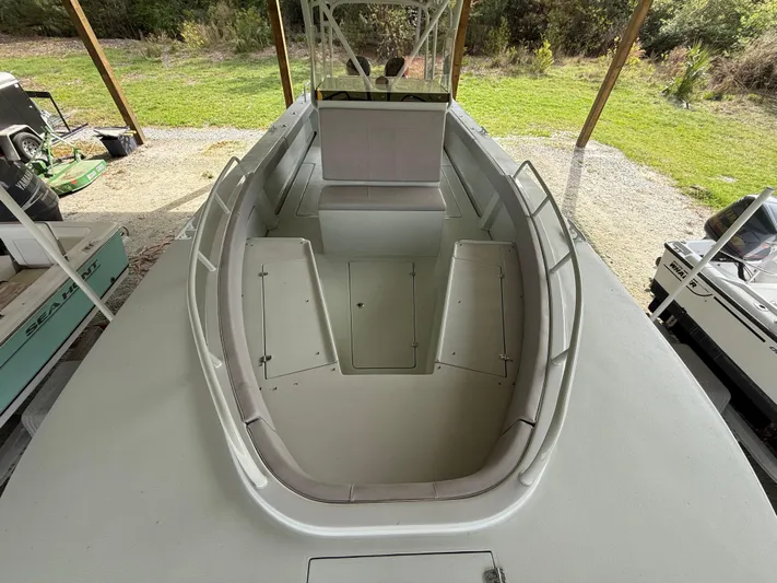  Yacht Photos Pics 2004 Boston Whaler Guardian 27 boat, spacious deck view, under a canopy.