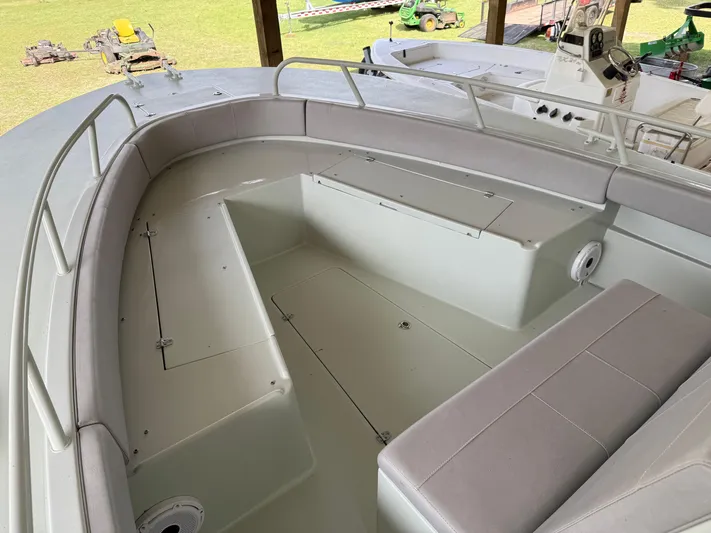  Yacht Photos Pics 2004 Boston Whaler Guardian 27 boat interior with cushioned seating and storage compartments.