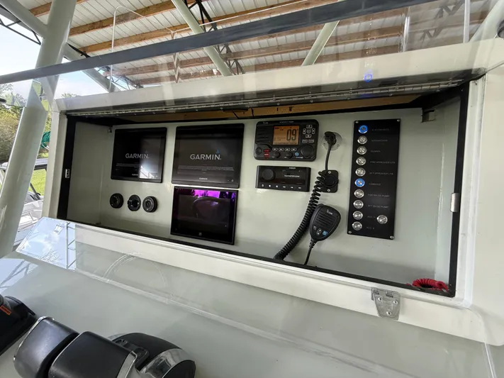  Yacht Photos Pics Control panel of a 2004 Boston Whaler Guardian 27 with Garmin electronics and communication devices.