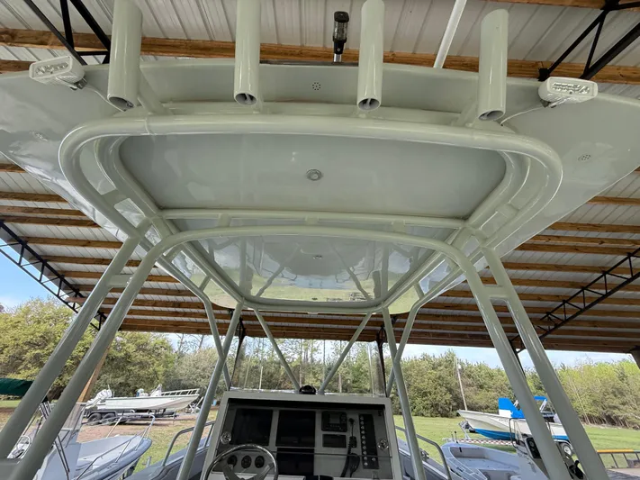 Yacht Photos Pics Boston Whaler Guardian 27, 2004 model, under a shelter with visible console and rod holders.