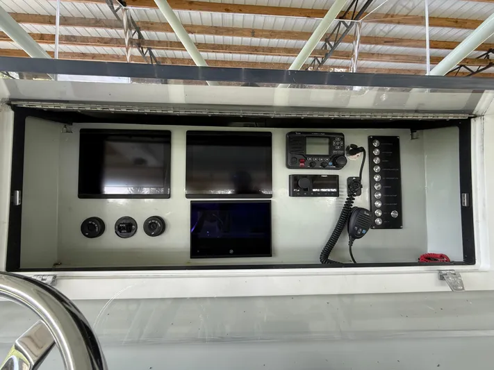  Yacht Photos Pics Control panel of a 2004 Boston Whaler Guardian 27 with screens and communication equipment.