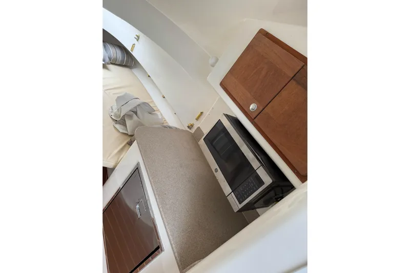  Yacht Photos Pics Interior of 2008 Contender 36 Fisharound with microwave and wooden cabinetry.