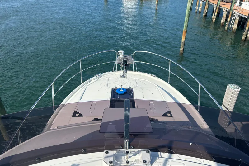 1095-953 Brokerage Josh Yacht Photos Pics 2024 Jeanneau NC Weekender 1095 Fly yacht docked on calm water.