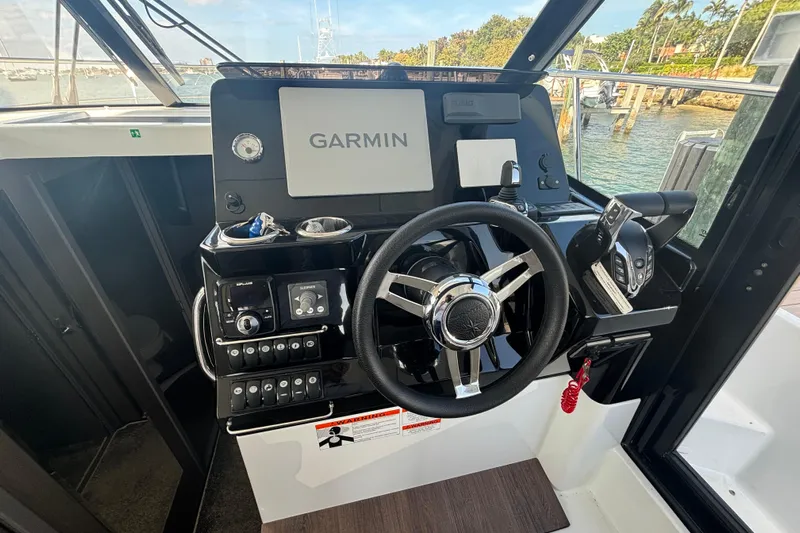 1095-953 Brokerage Josh Yacht Photos Pics 2024 Jeanneau NC Weekender 1095 Fly helm with Garmin navigation system.