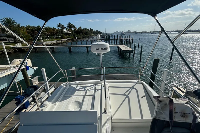 1095-953 Brokerage Josh Yacht Photos Pics 2024 Jeanneau NC Weekender 1095 Fly, docked with scenic waterfront view.