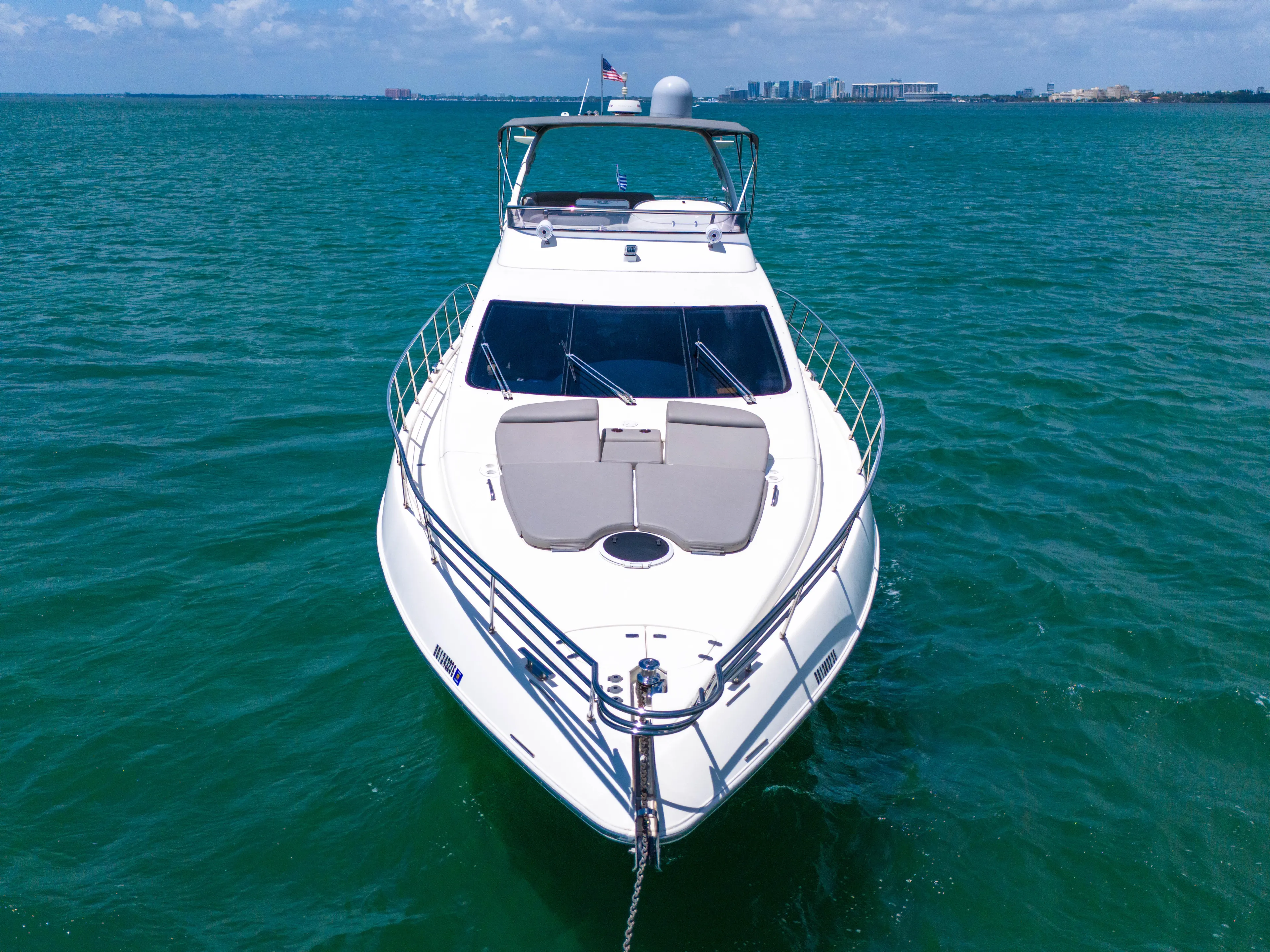 Bellami Too Yacht Photos Pics 2008 Azimut 62E yacht on open water, clear sky, and distant shoreline.