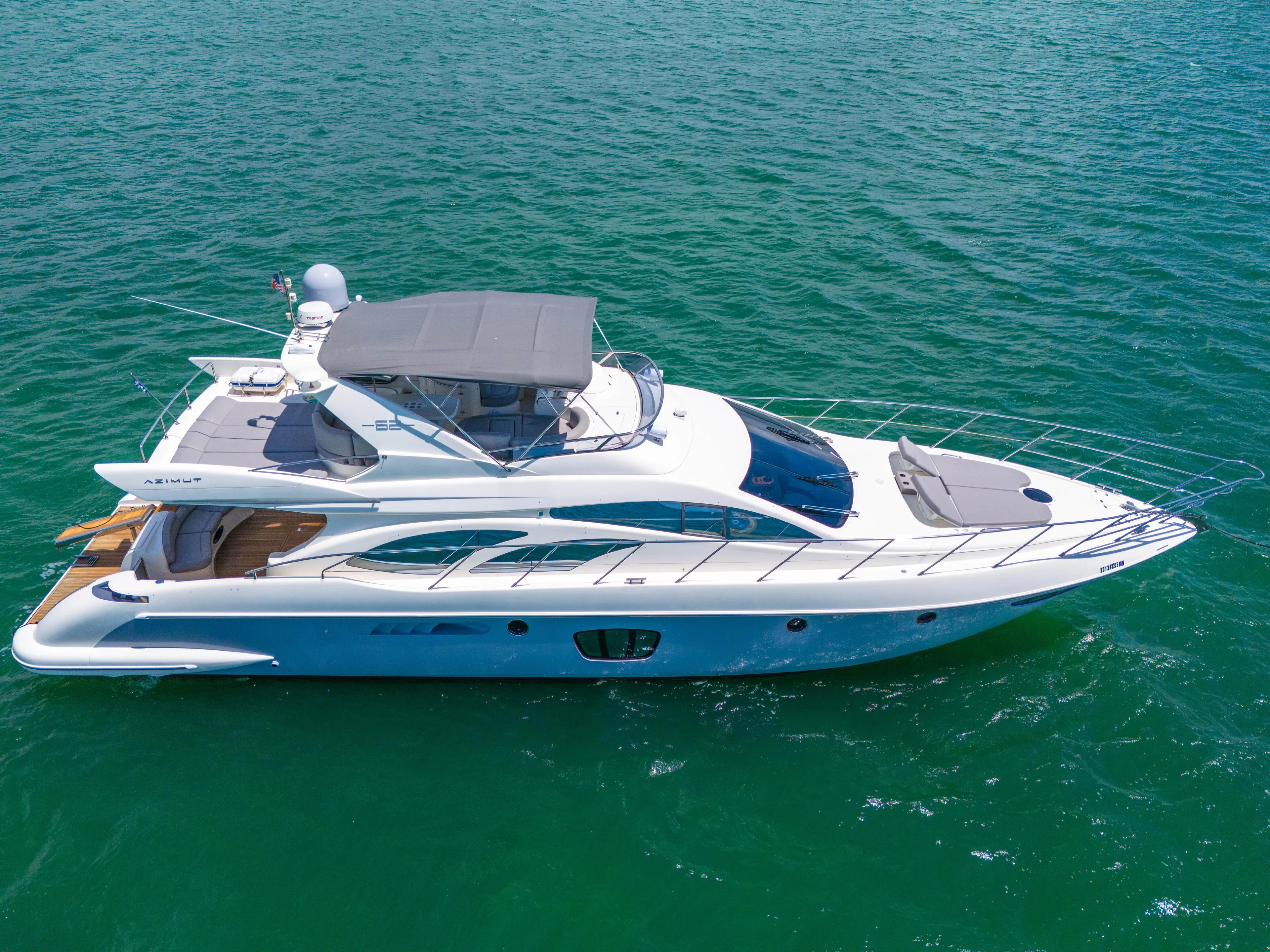 Bellami Too Yacht Photos Pics 2008 Azimut 62E yacht cruising on clear blue waters.