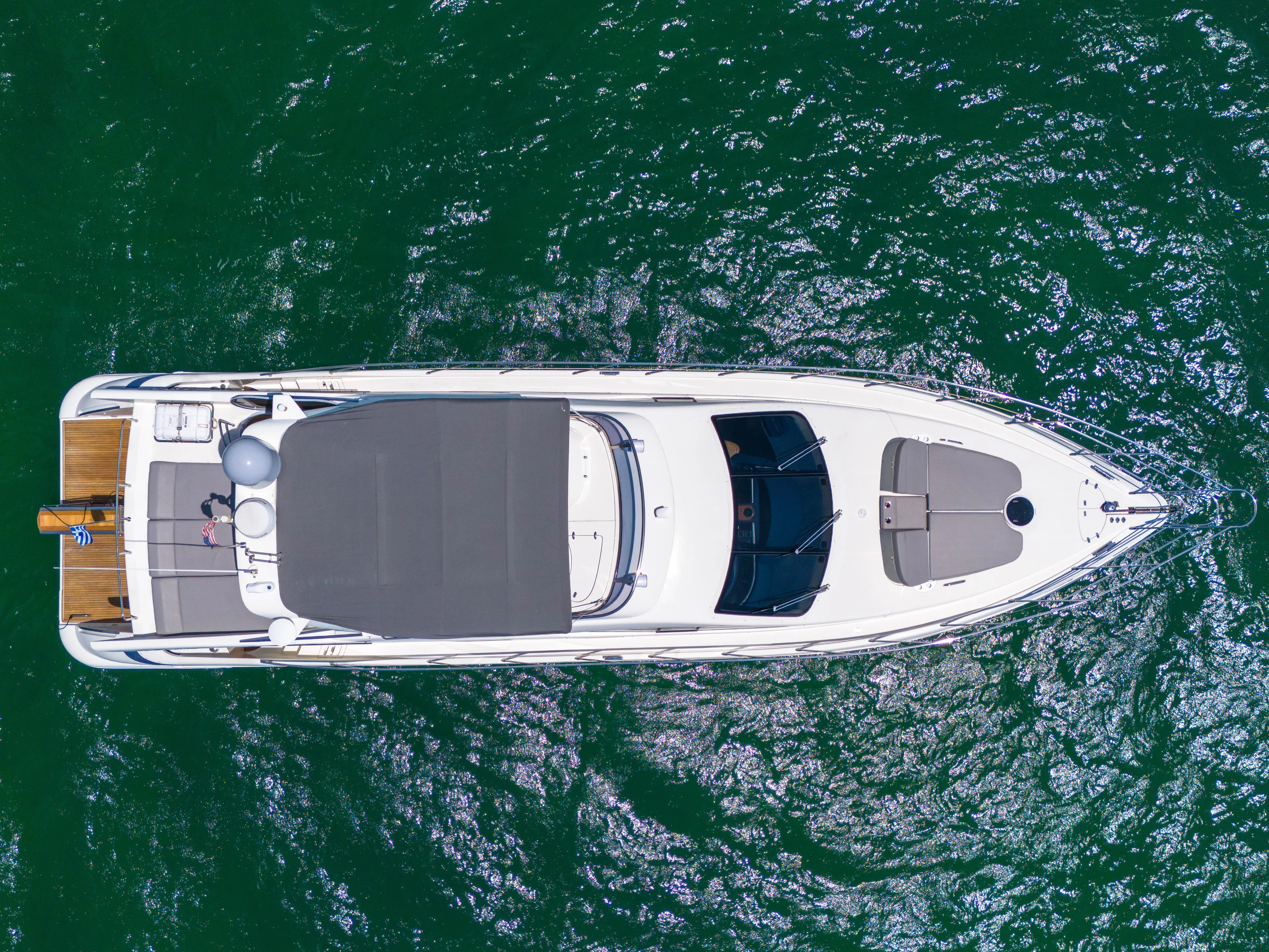 Bellami Too Yacht Photos Pics Aerial view of 2008 Azimut 62E yacht on green water.